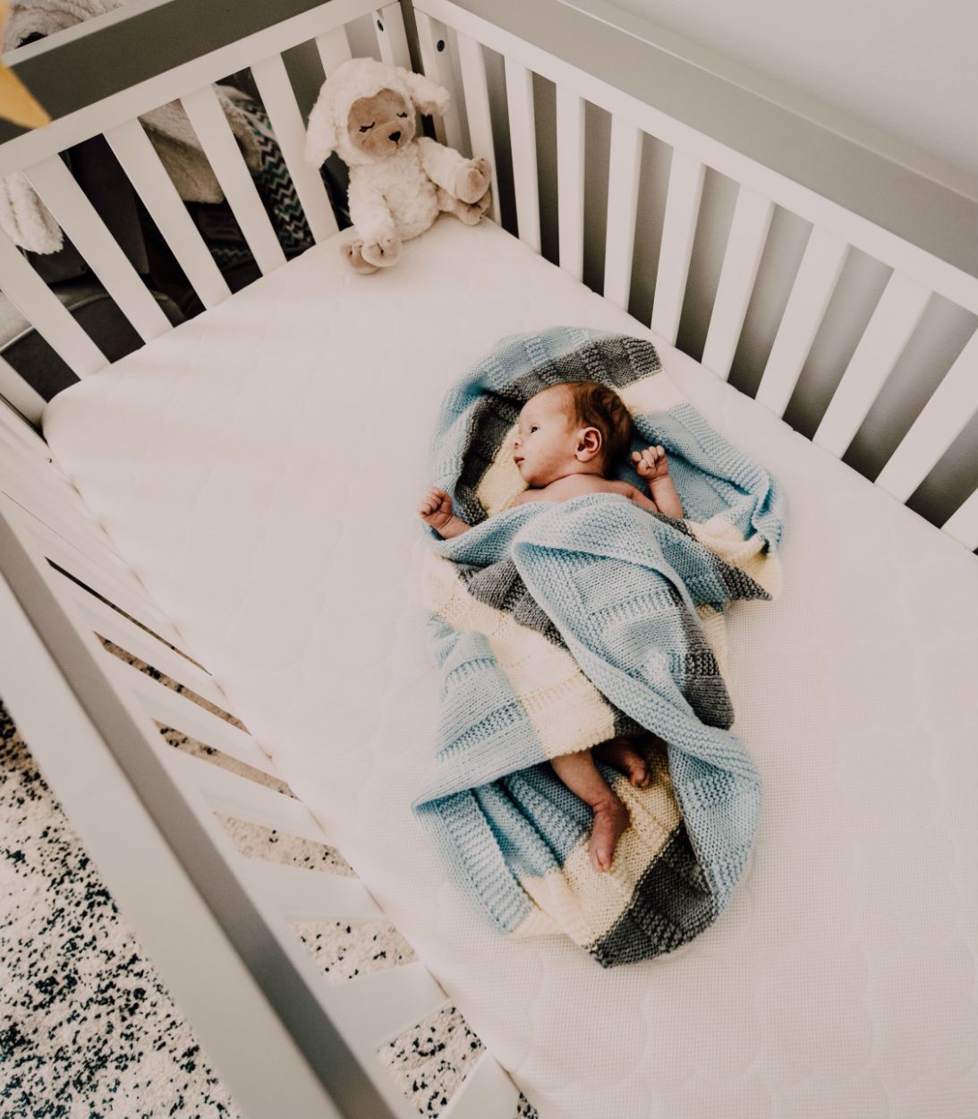 Infant sleeping in a cot
