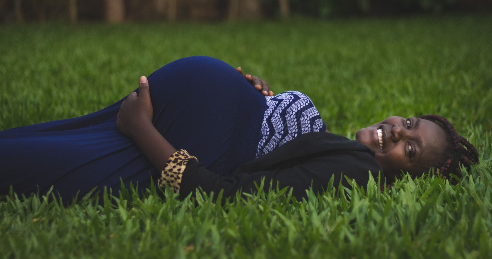 A woman on her back to the ground while pregnant