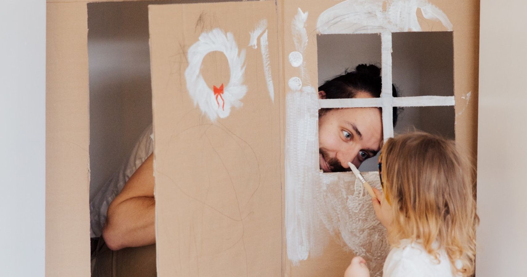 Father and daughter having fun with paint
