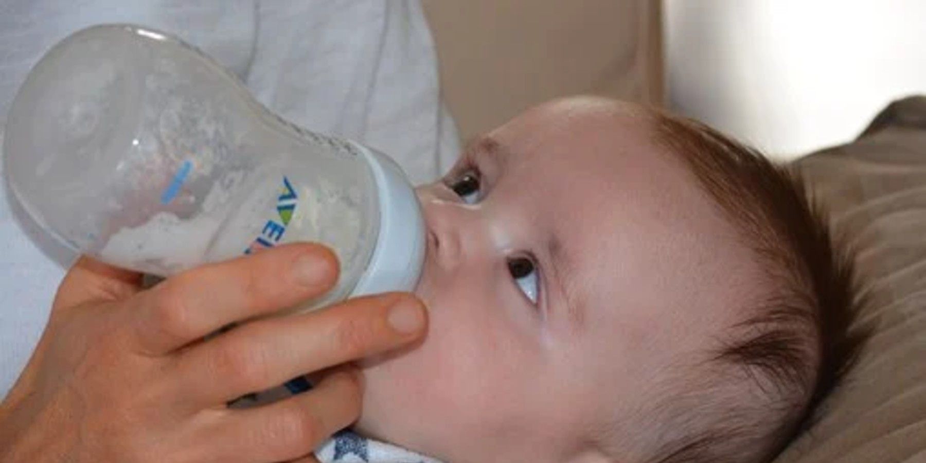 Baby being bottle-fed, and they are not the world's longest breastfed baby.