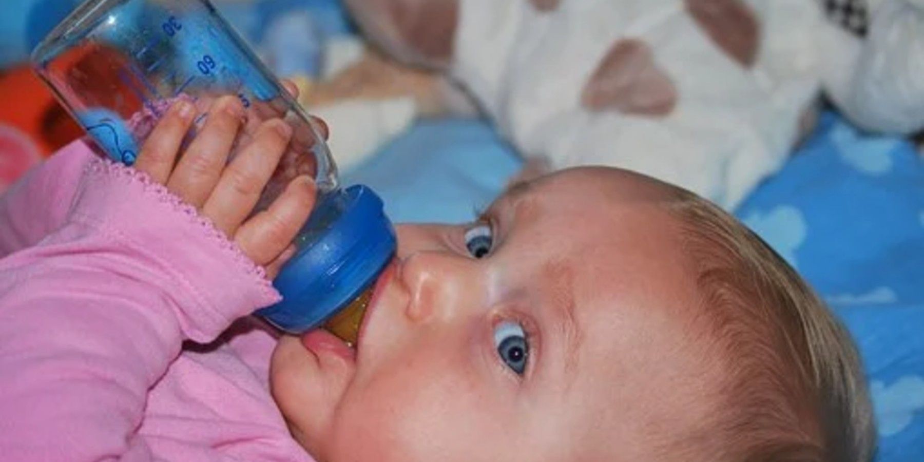 Child being fed through a bottle, and they are not the world's longest breastfed baby.