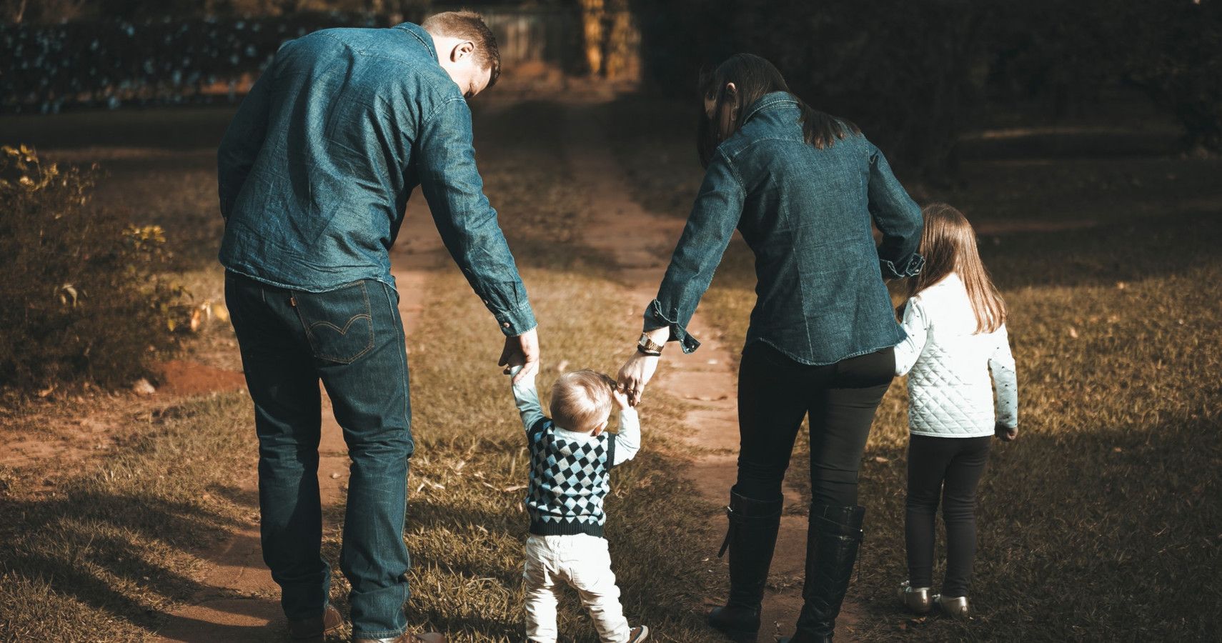 Parents walking together with their two children.