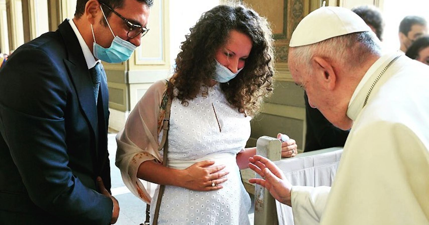 The Pope blessing a couple's unborn child