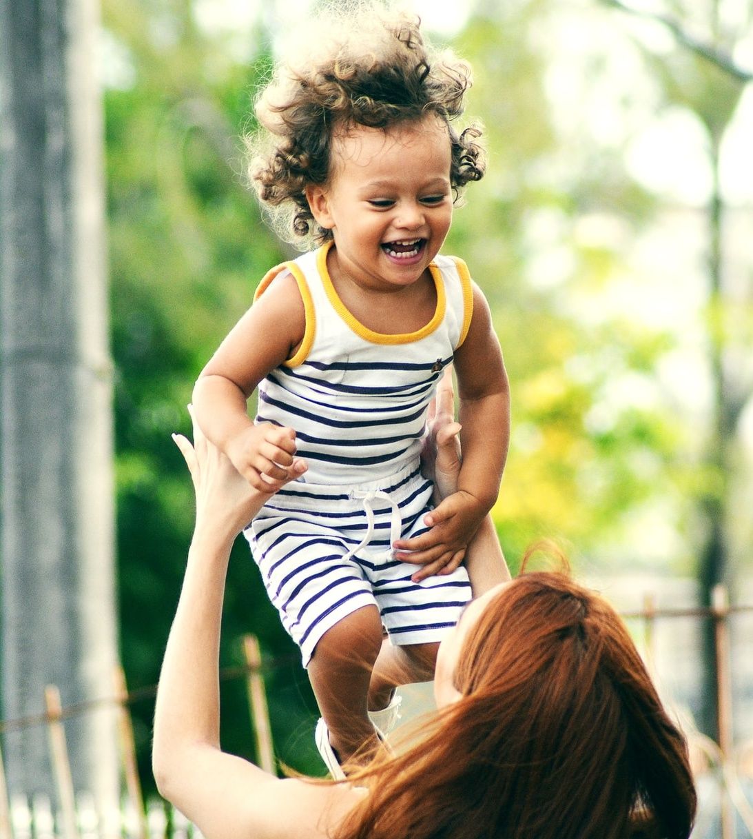 a Happy mom playing with her baby