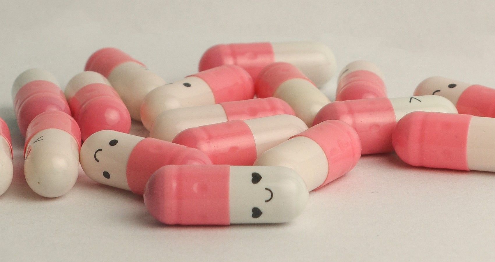 A pile of pills with small happy faces on them