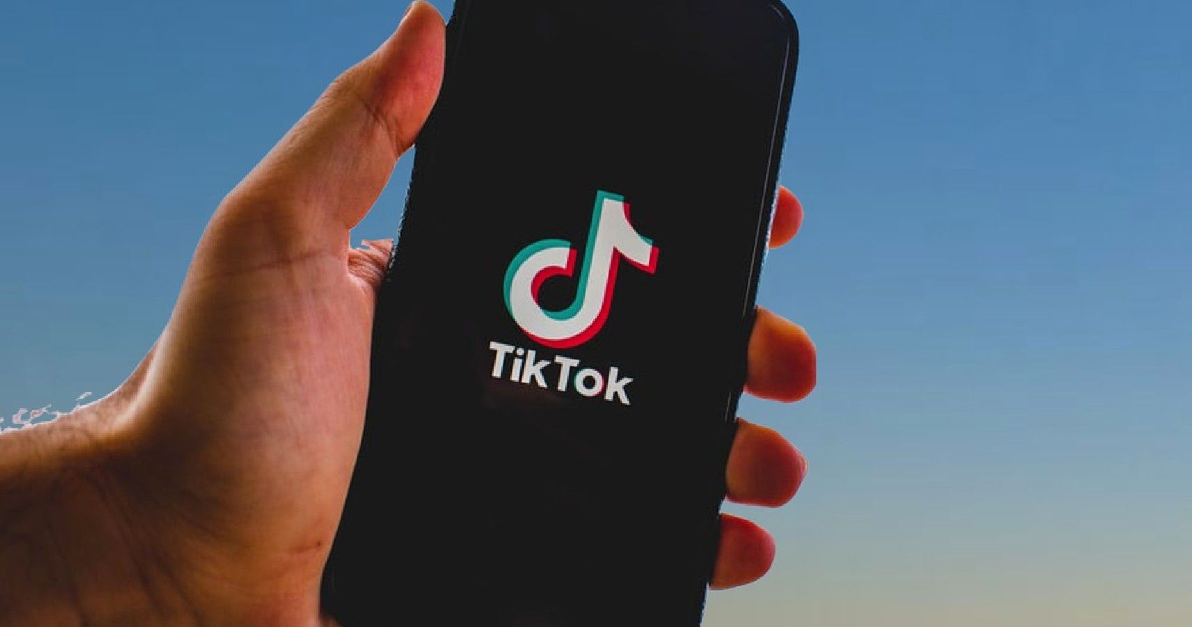 Picture of phone and TikTok logo on the screen