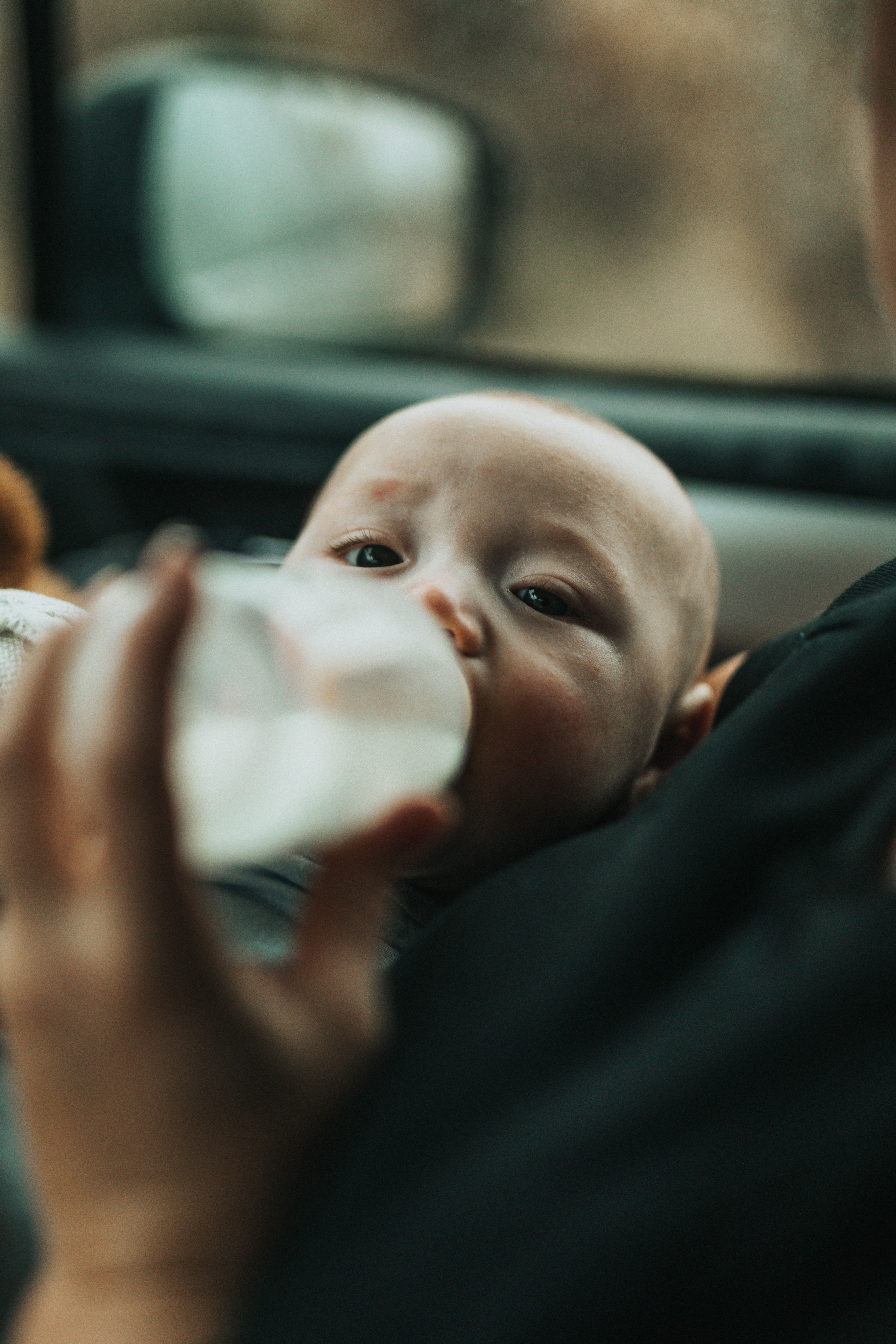 Baby fed bottle in car