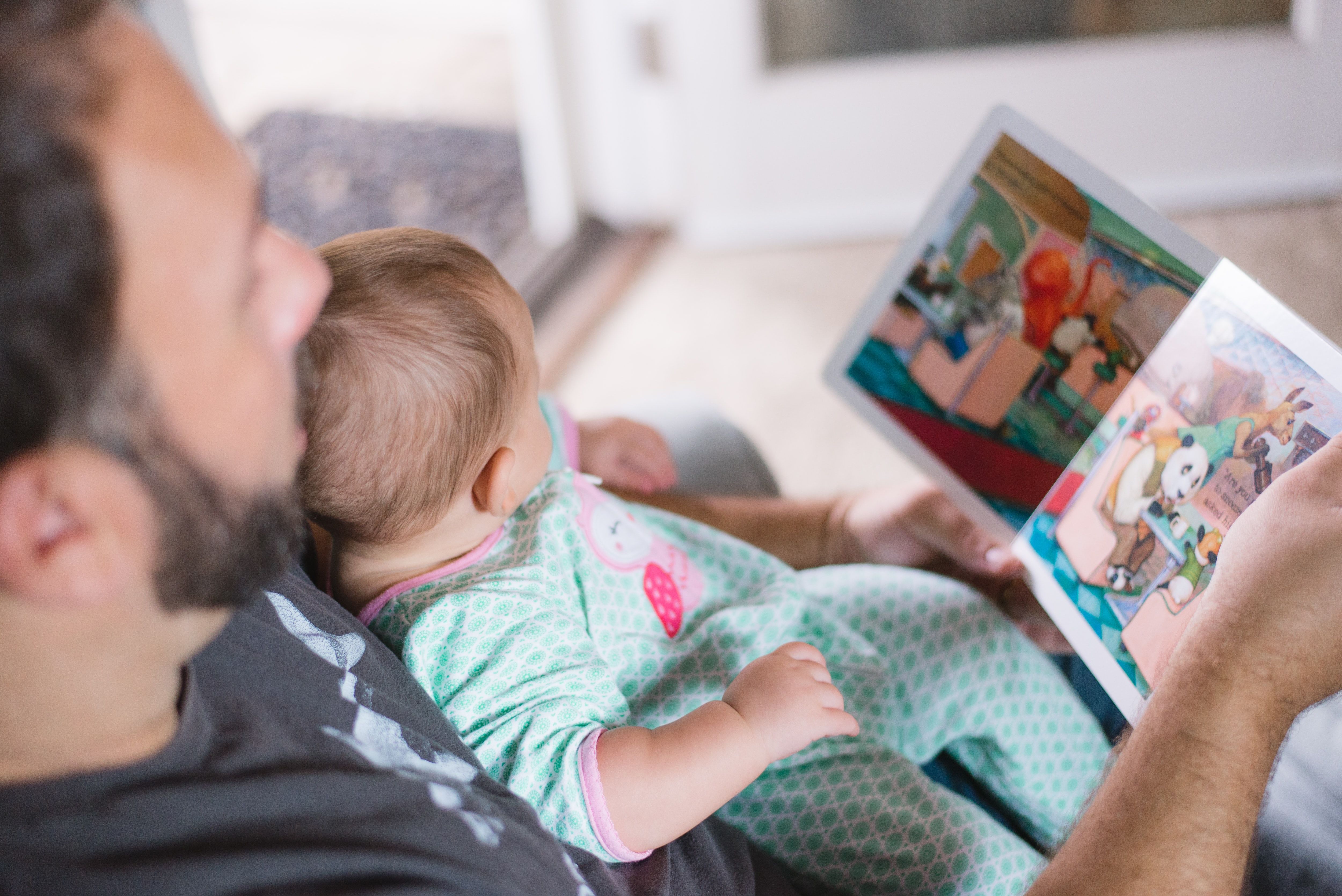 Baby reading with dad