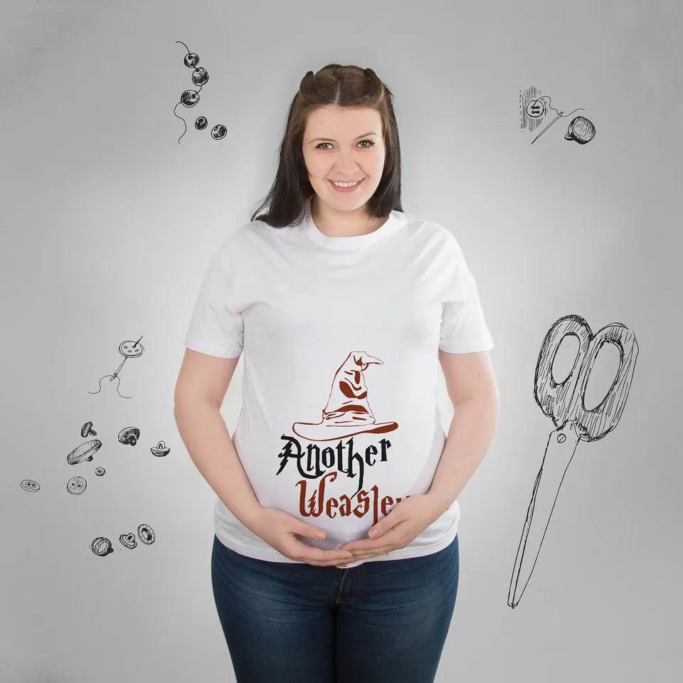 Pregnant woman holding belly and wearing