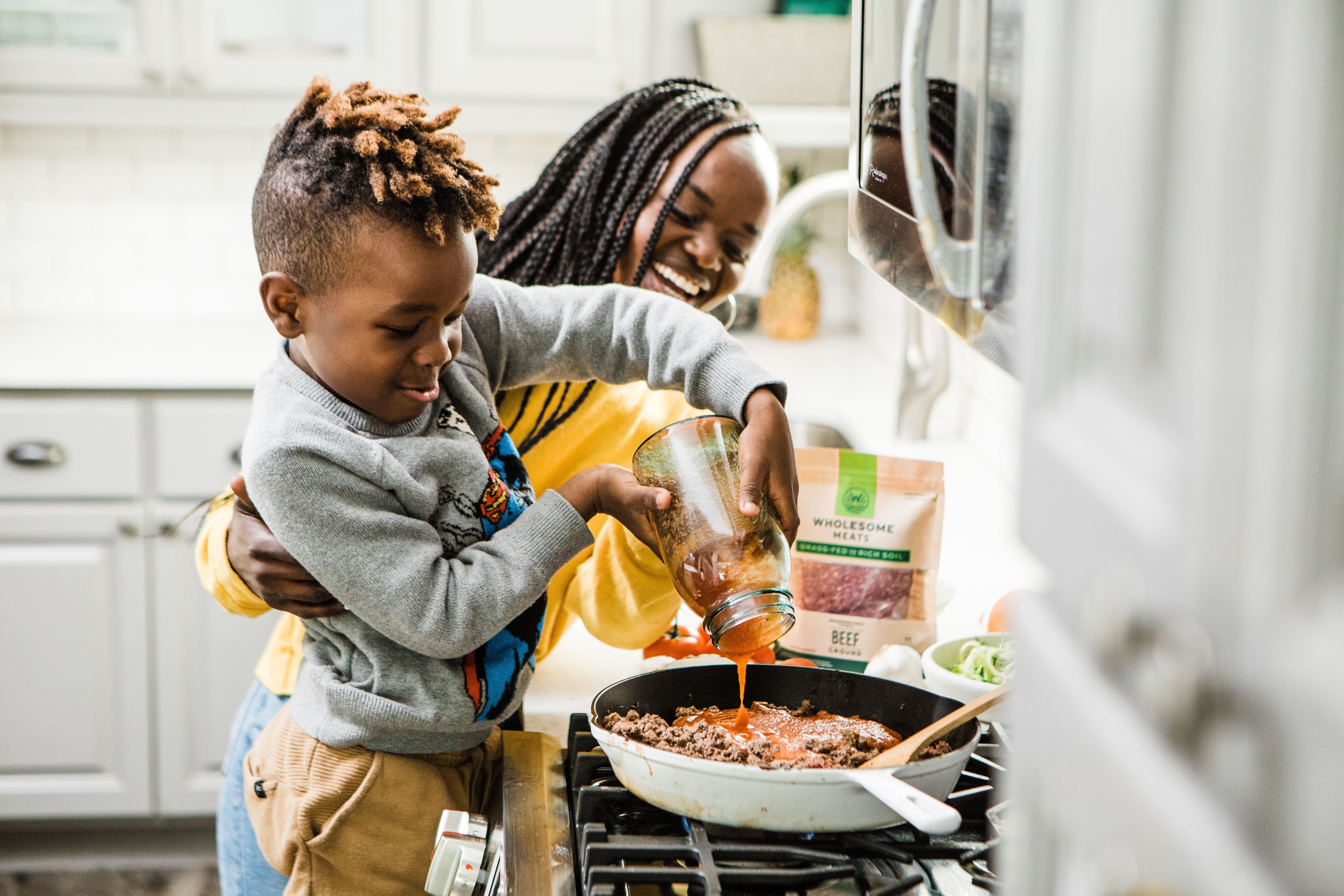 Toddler cooking with mother