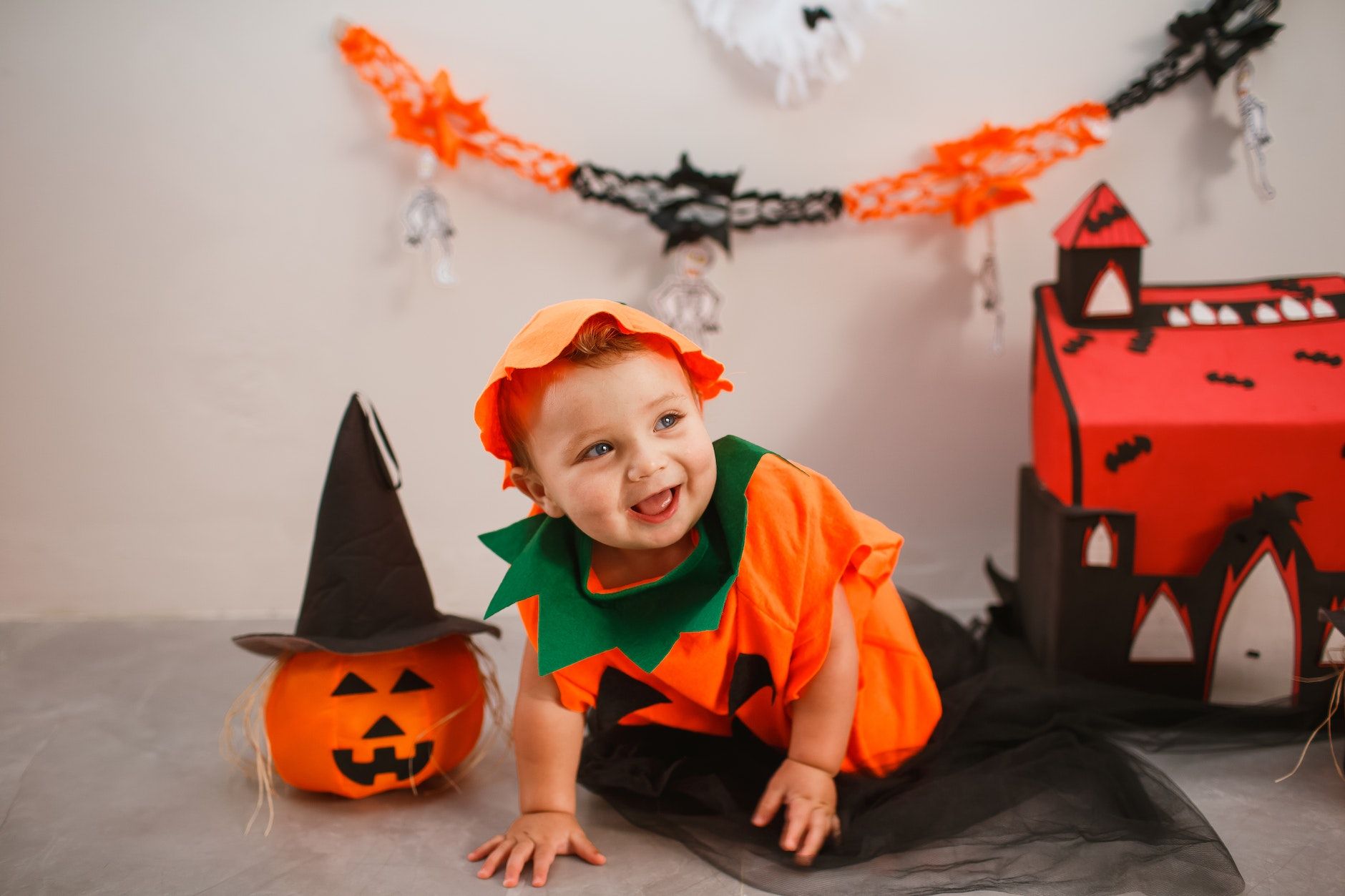 baby dressed in pumpkin costume