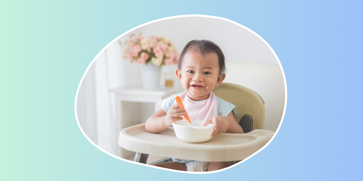 blue green background and a baby smiling in a high chair